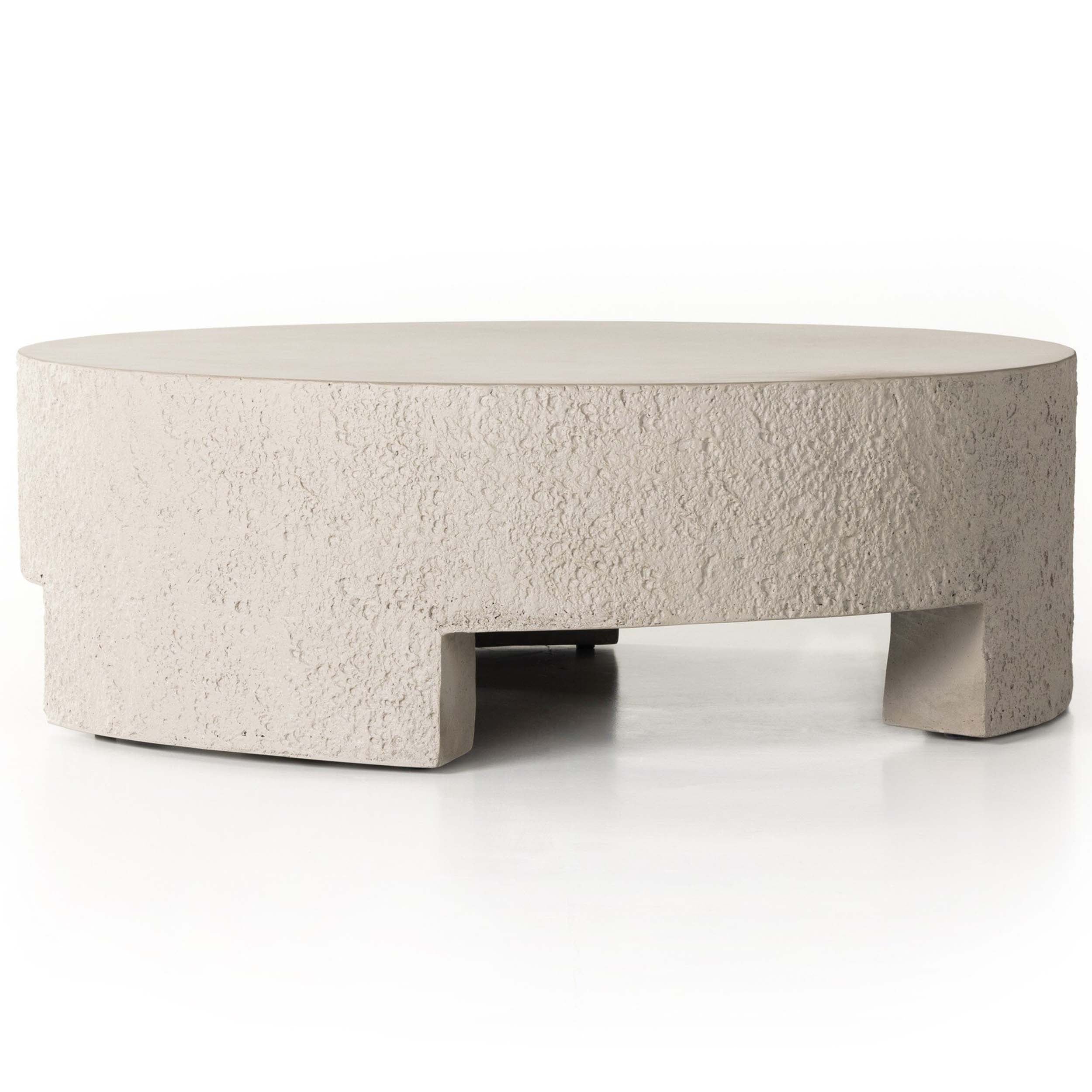 Kember Outdoor Coffee Table, Matte Stone with bold sculptural design and cutout legs, suitable for outdoor spaces.