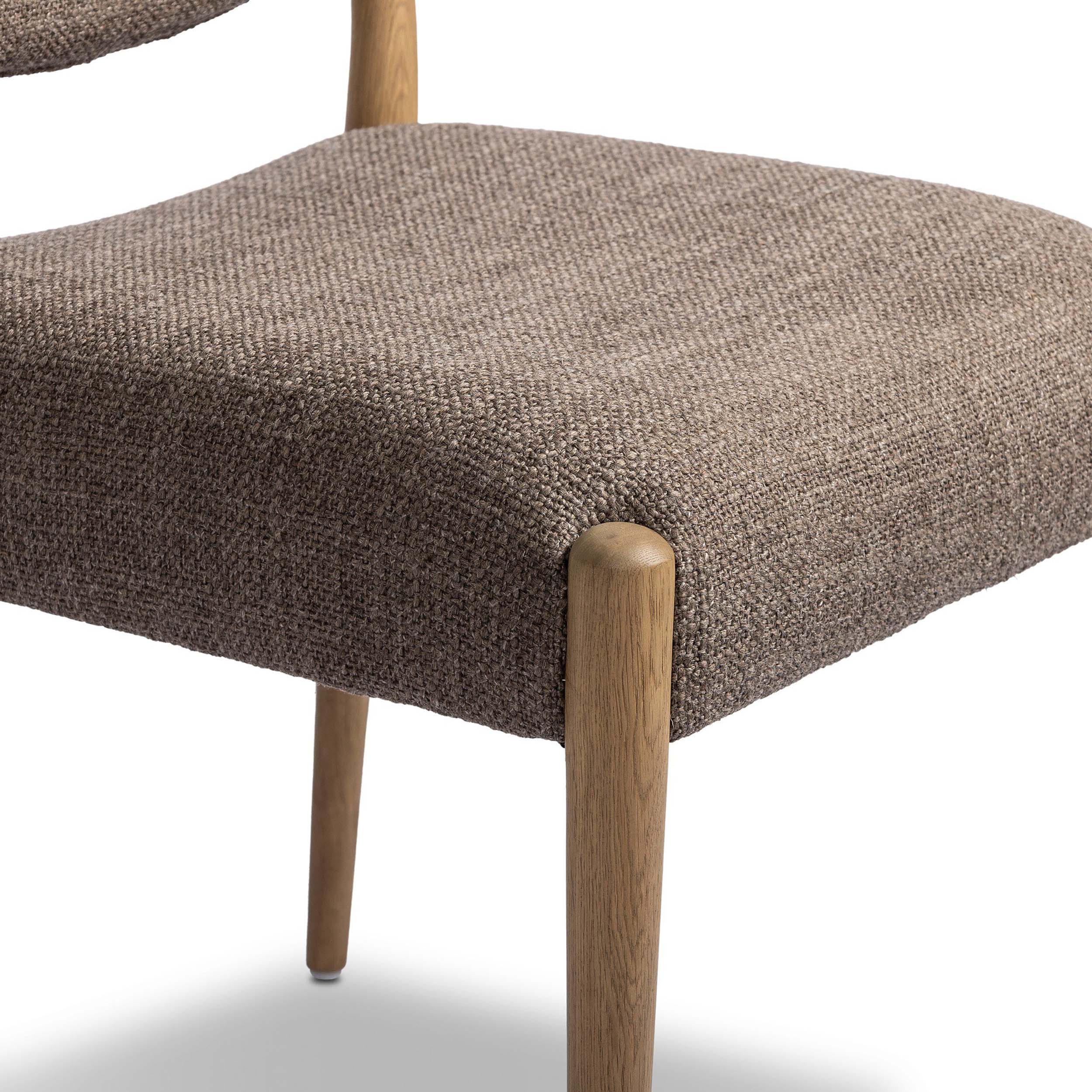 Jayla Armless Dining Chair, Saxon Mink, Set of 2 showing textured upholstery and natural oak legs.