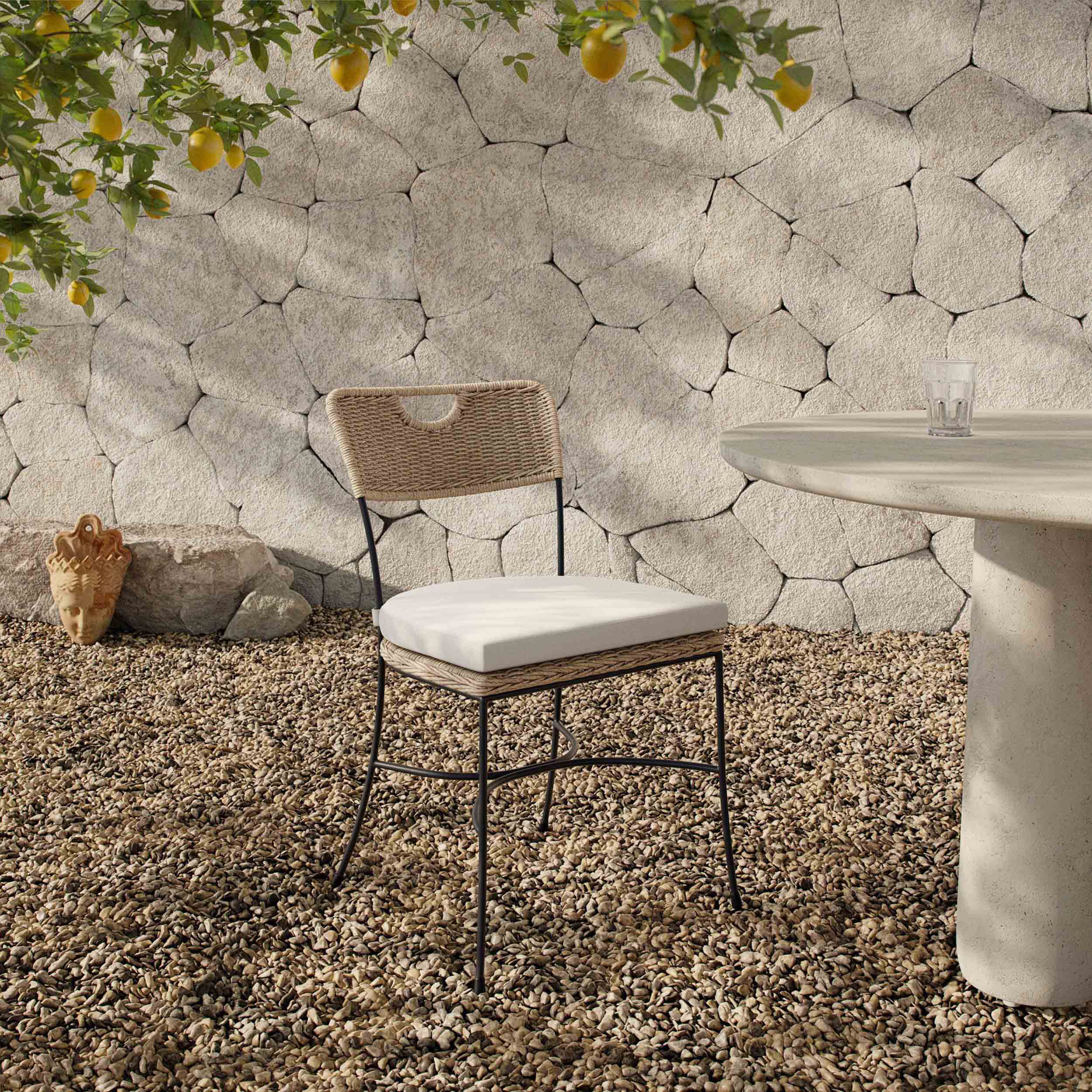 Honor Outdoor Dining Chair, Arashi Salt, Set of 2 with woven seat and charcoal legs in an outdoor setting.