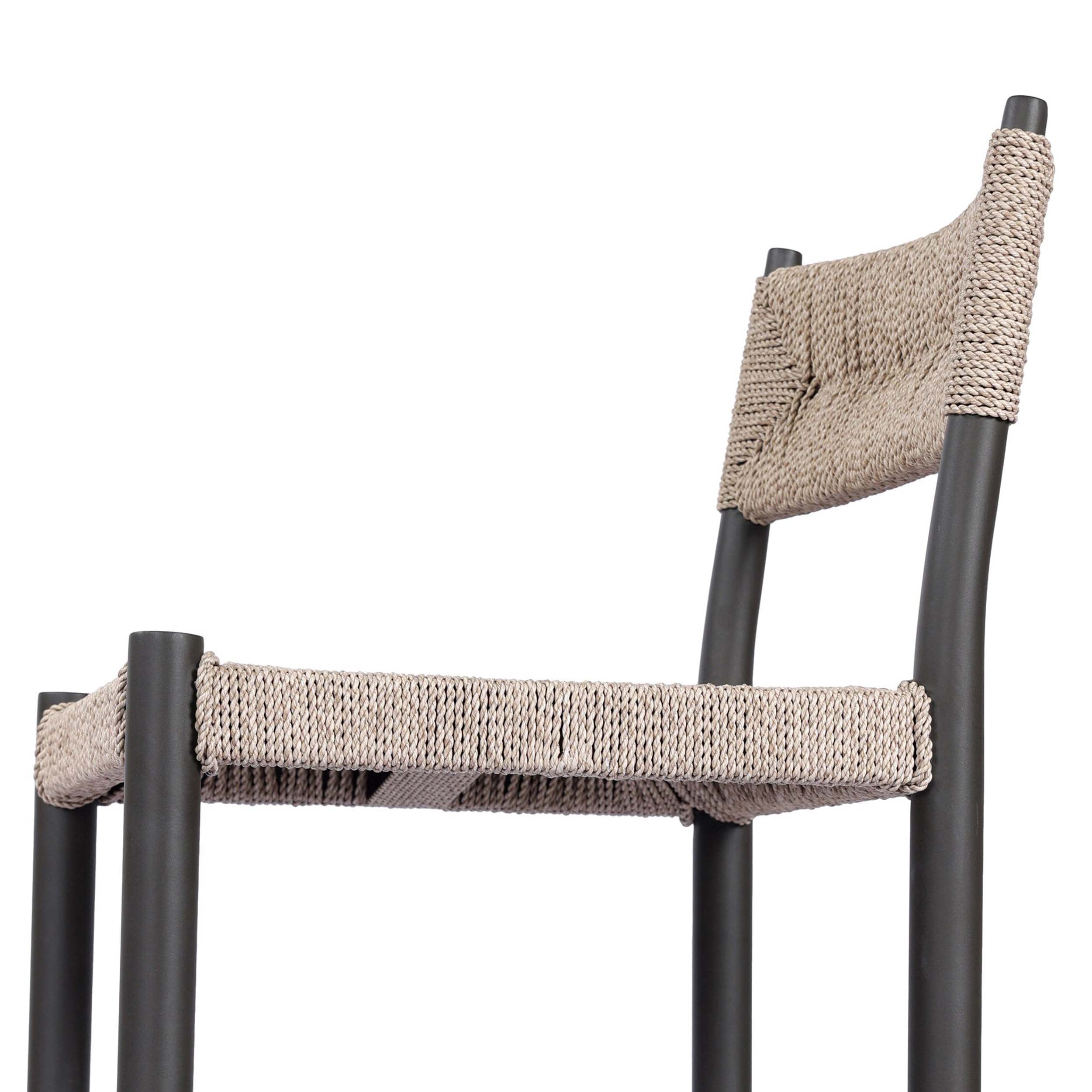 Lomas Outdoor Metal Bar + Counter Stool, Textured Dune featuring a woven wicker seat and dark bronze frame.