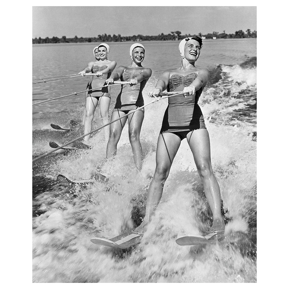Four Young Woman Waterskiing in the Sea
