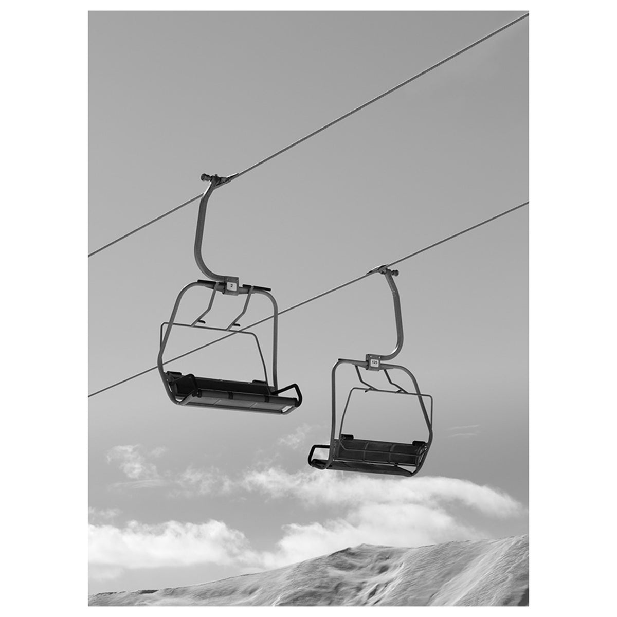 Black and White Chair Lifts and Snowy Winter High Mountains